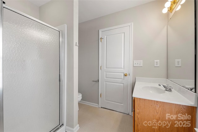 bathroom with a stall shower, baseboards, toilet, tile patterned floors, and vanity