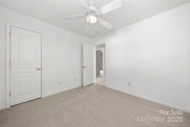 unfurnished bedroom featuring a ceiling fan, baseboards, and carpet flooring