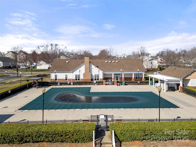 community pool featuring a patio area and fence