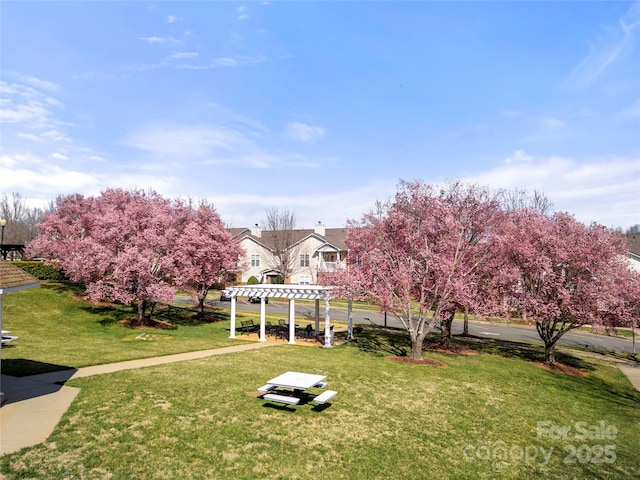 exterior space featuring a pergola and a yard