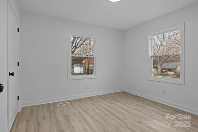 unfurnished bedroom with baseboards, visible vents, and light wood finished floors