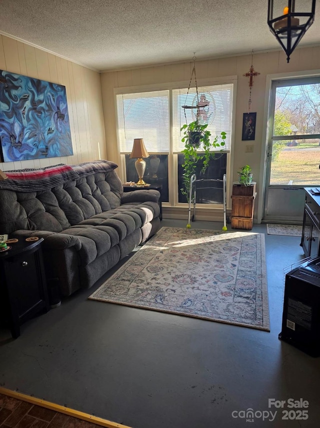 living area with concrete flooring and a textured ceiling