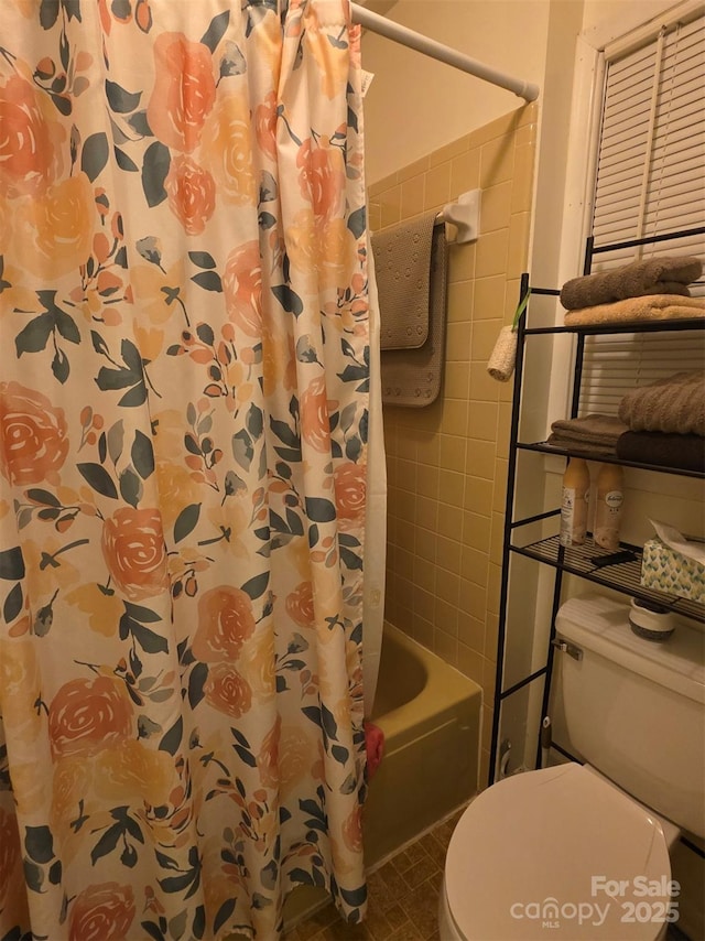 bathroom with shower / bathtub combination with curtain and toilet