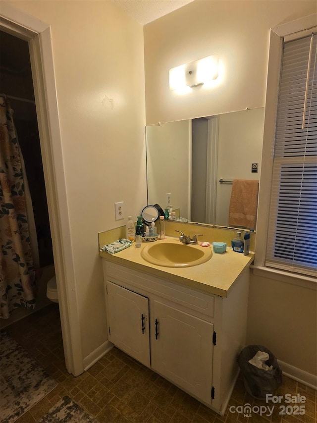 bathroom with vanity and baseboards