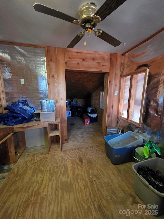 bedroom featuring wooden walls and wood finished floors