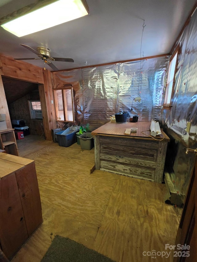 interior space featuring cooling unit, wood finished floors, vaulted ceiling, and ceiling fan