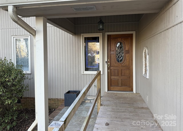 view of exterior entry with crawl space and visible vents