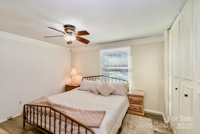 bedroom with crown molding, a textured ceiling, and wood finished floors