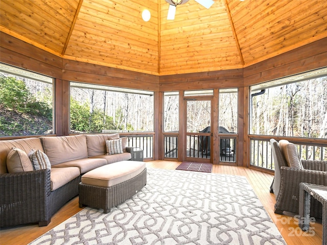 sunroom / solarium featuring a wealth of natural light and vaulted ceiling