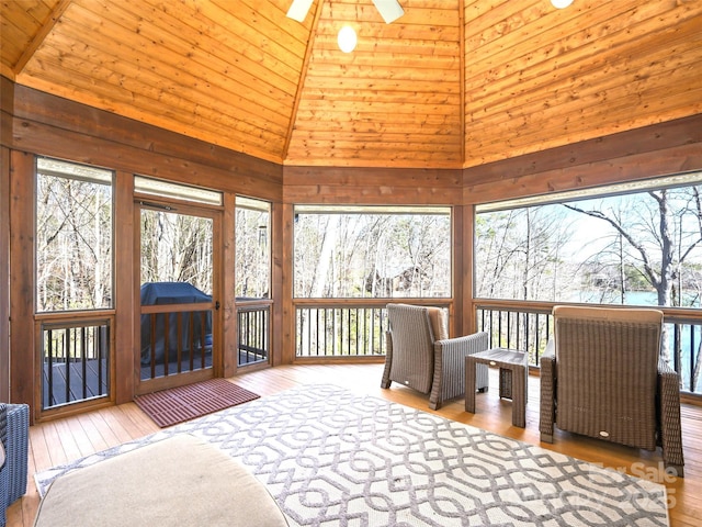 sunroom / solarium featuring lofted ceiling