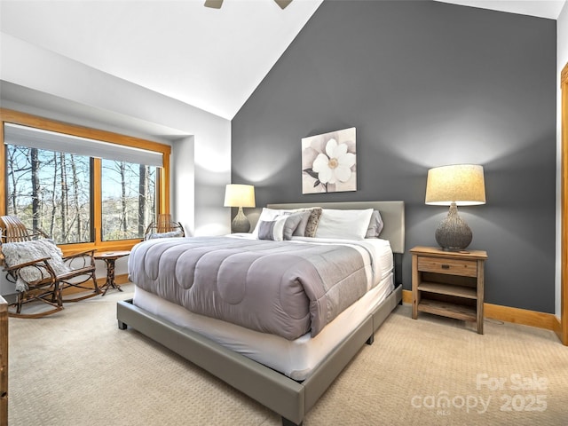 bedroom with high vaulted ceiling, light colored carpet, ceiling fan, and baseboards