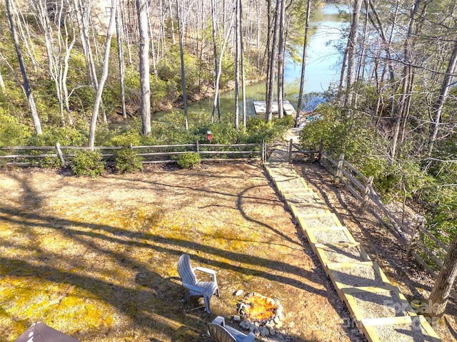 view of yard featuring a water view and fence