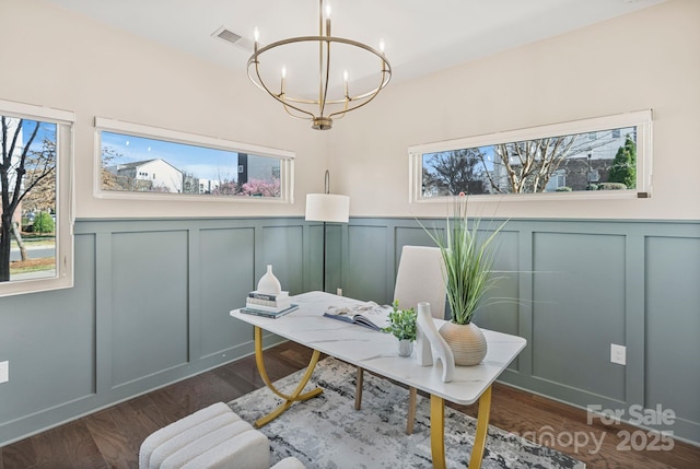 home office with a chandelier, a wealth of natural light, and wood finished floors