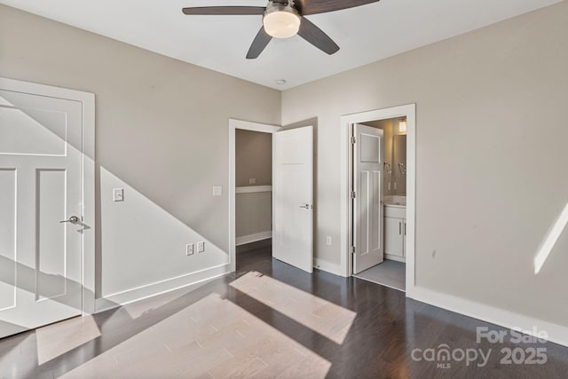 bedroom featuring ensuite bath, wood finished floors, a ceiling fan, and baseboards