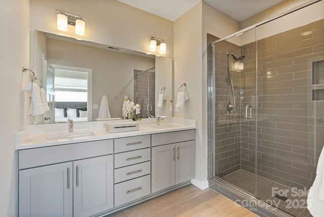 full bath featuring a stall shower, a sink, ensuite bath, and double vanity