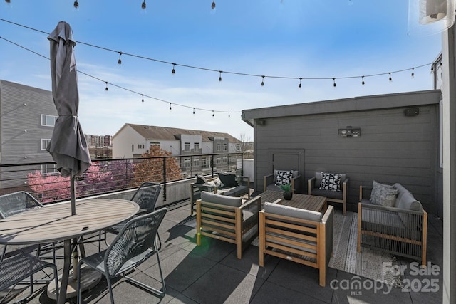 view of patio / terrace with a balcony and outdoor lounge area