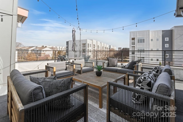 view of patio featuring a balcony and an outdoor living space