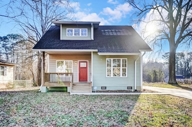 bungalow featuring a shingled roof, a front yard, crawl space, and covered porch