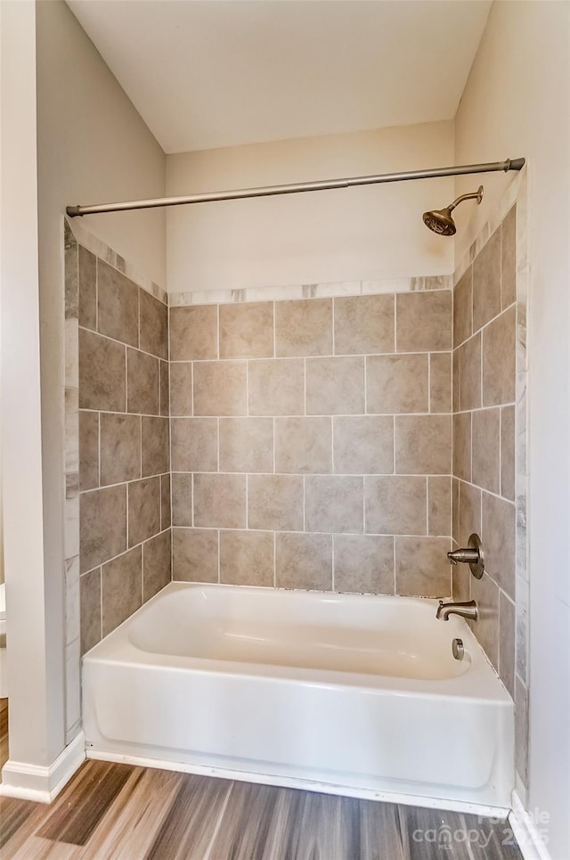 full bath with tub / shower combination and wood finished floors