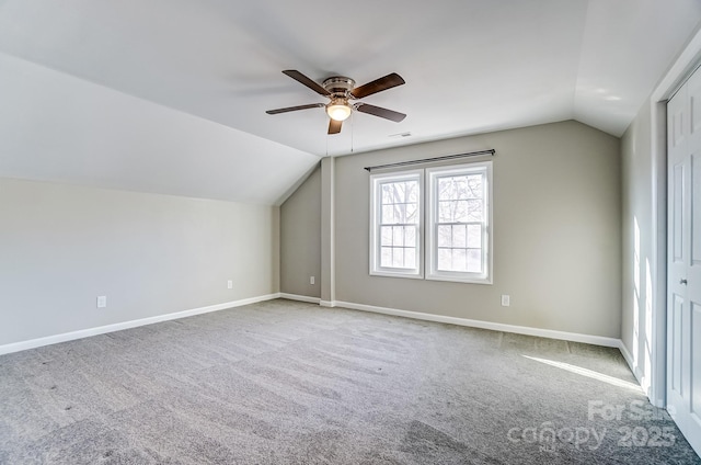 additional living space featuring lofted ceiling, ceiling fan, carpet flooring, and baseboards