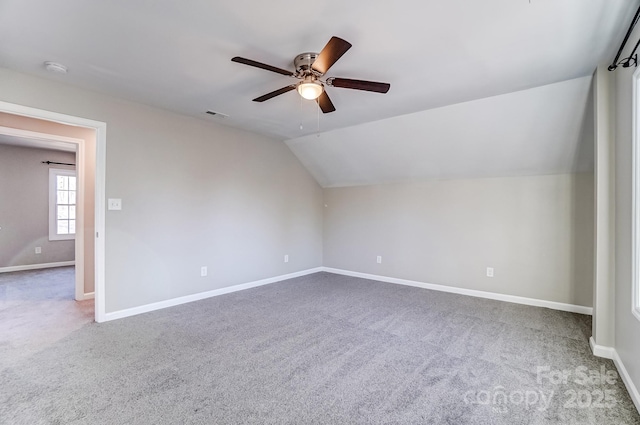 bonus room with lofted ceiling, carpet, visible vents, and baseboards