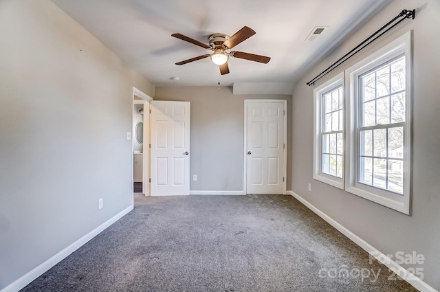 unfurnished bedroom with baseboards, visible vents, ceiling fan, and carpet flooring