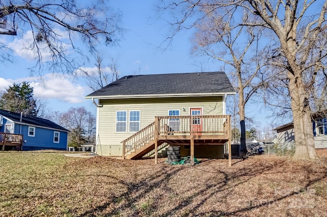 rear view of house with central air condition unit, a shingled roof, a yard, stairway, and a wooden deck