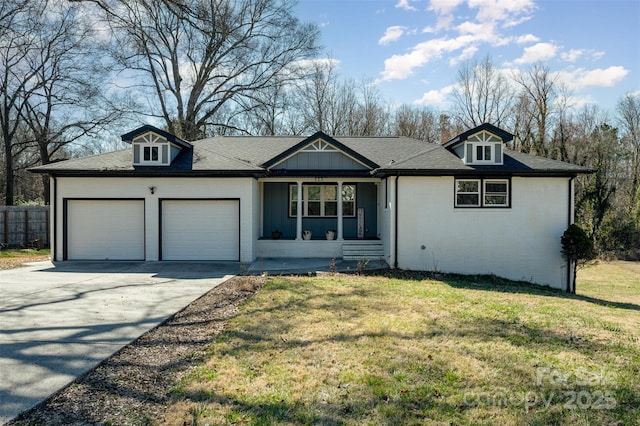 ranch-style house featuring brick siding, covered porch, an attached garage, a front yard, and driveway