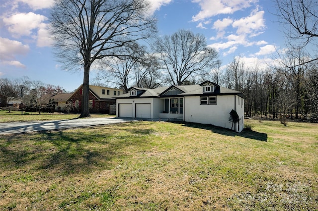 view of front of property with an attached garage, concrete driveway, and a front yard