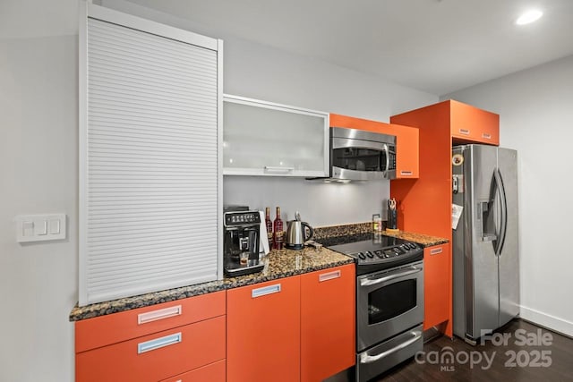 kitchen featuring dark wood finished floors, dark stone counters, appliances with stainless steel finishes, open shelves, and recessed lighting