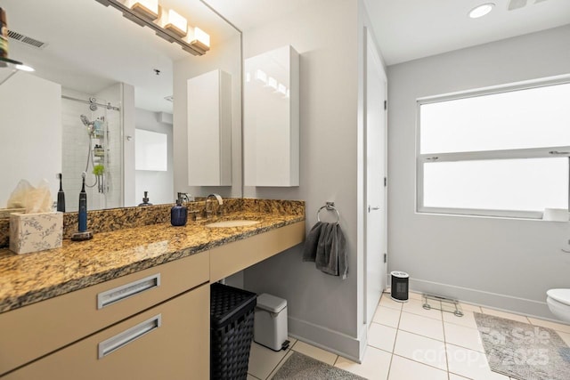 full bathroom featuring toilet, visible vents, baseboards, tile patterned floors, and walk in shower