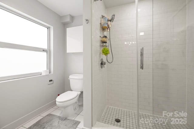 full bathroom with tile patterned flooring, baseboards, a shower stall, and toilet