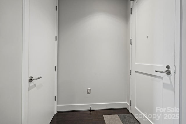 unfurnished room featuring dark wood-style floors and baseboards