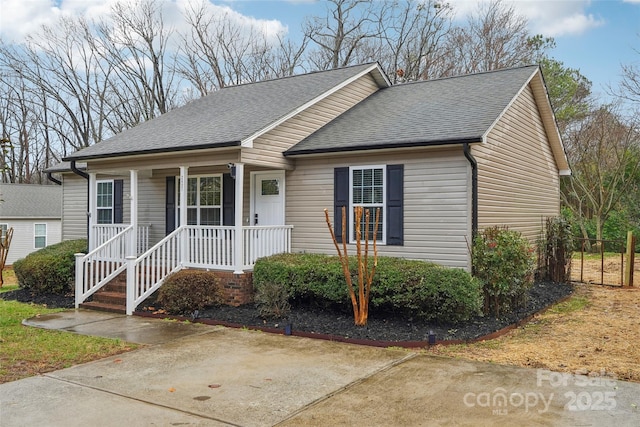 view of front of property with covered porch and roof with shingles