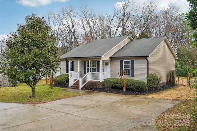 single story home with roof with shingles, a porch, and a front yard