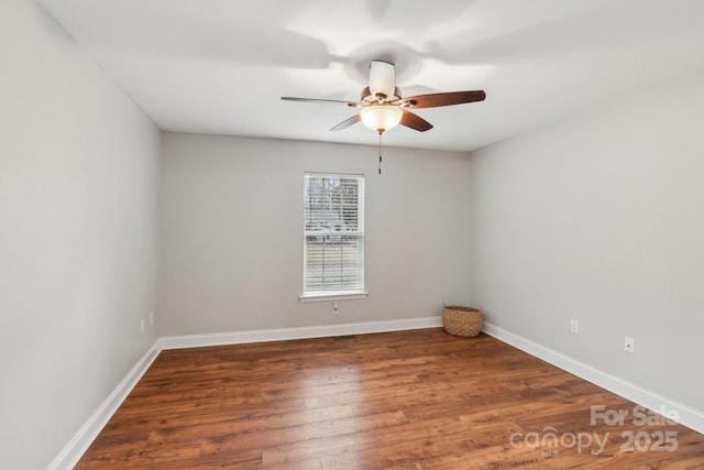 spare room with ceiling fan, baseboards, and wood finished floors