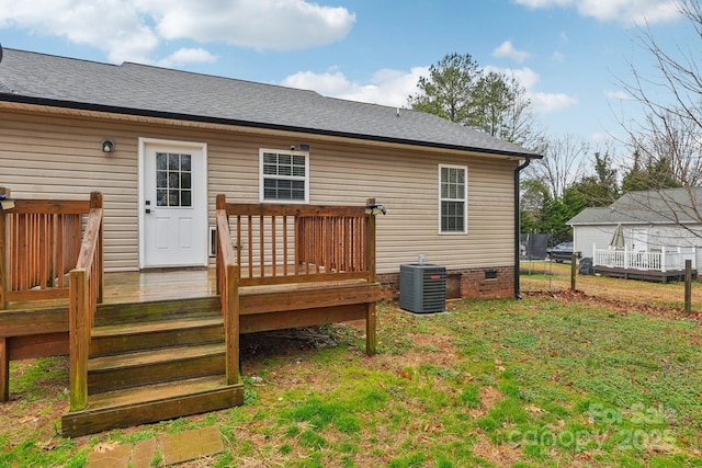 rear view of house featuring a wooden deck, central AC unit, roof with shingles, crawl space, and a yard