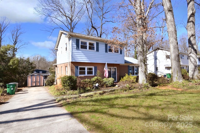 colonial inspired home featuring an outbuilding, a shed, a front yard, and brick siding