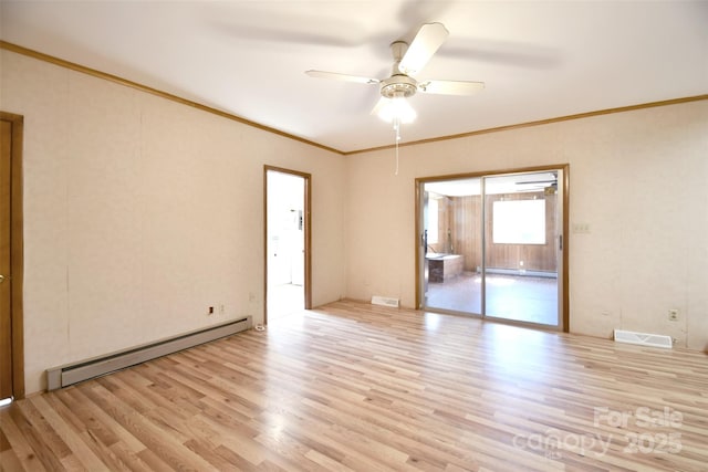 spare room with light wood finished floors, visible vents, a baseboard heating unit, and crown molding