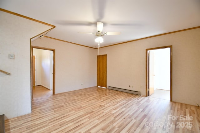 unfurnished room featuring light wood-style floors, baseboard heating, and crown molding