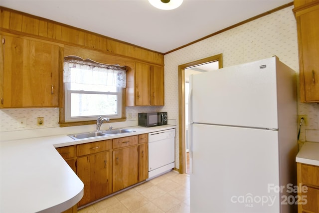 kitchen featuring white appliances, light countertops, wallpapered walls, and brown cabinetry