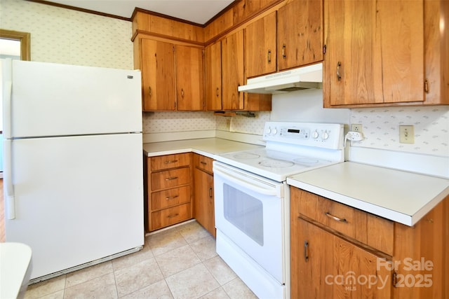 kitchen with light countertops, brown cabinetry, white appliances, under cabinet range hood, and wallpapered walls