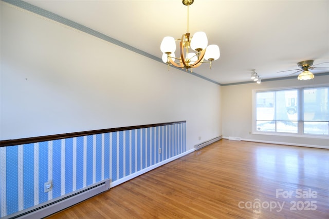 unfurnished room with ceiling fan with notable chandelier, a baseboard radiator, crown molding, and wood finished floors