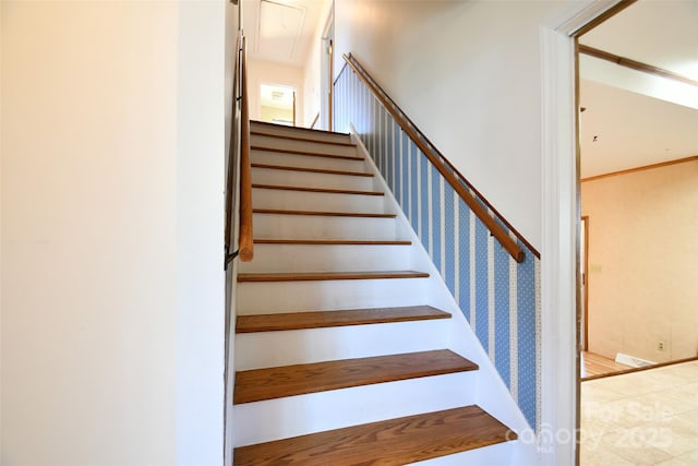 stairs with attic access and baseboards