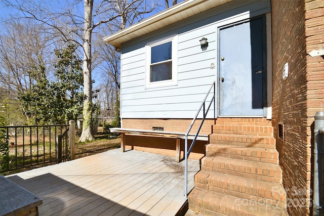 property entrance featuring a deck and crawl space