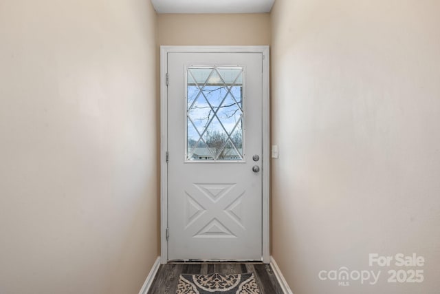 entryway with dark wood-style floors and baseboards