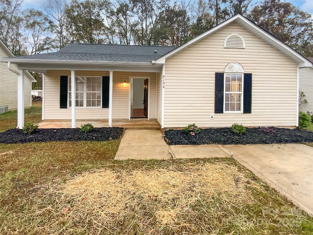 view of front of house featuring covered porch and roof with shingles