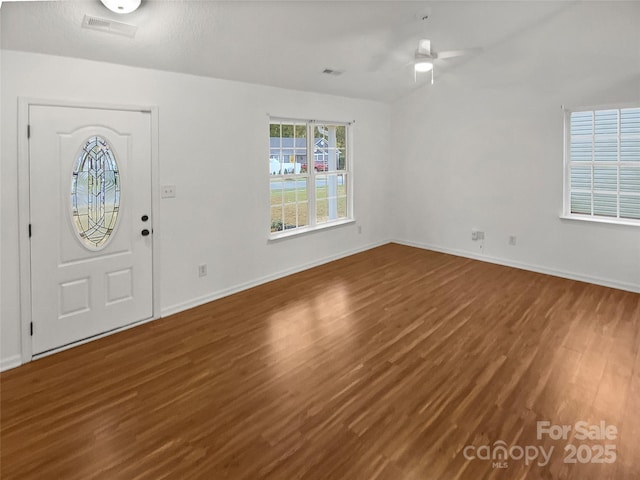 entrance foyer featuring a ceiling fan, visible vents, baseboards, and wood finished floors