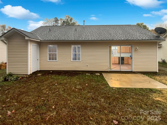 back of property with a patio, a yard, and roof with shingles