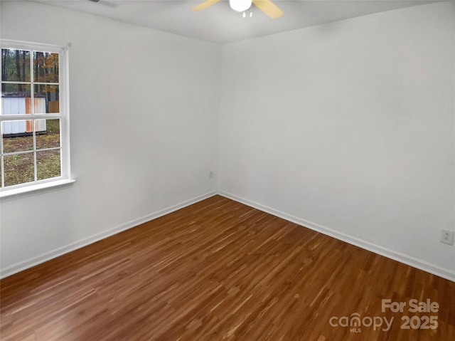 unfurnished room featuring a ceiling fan, baseboards, and wood finished floors